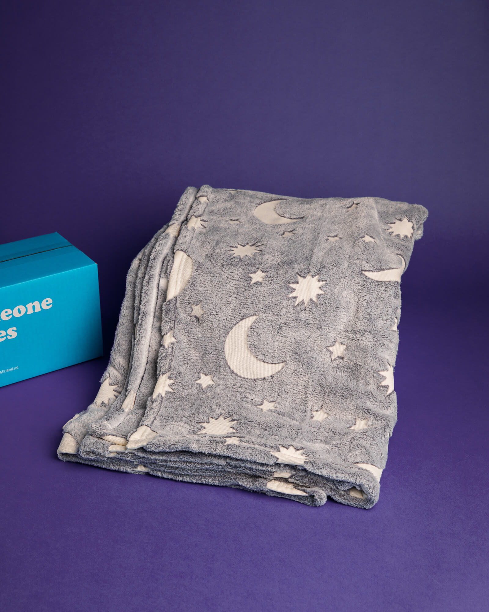 Photo of grey cozy moon and stars blanket included with the Deluxe To The Moon & Back Bundle