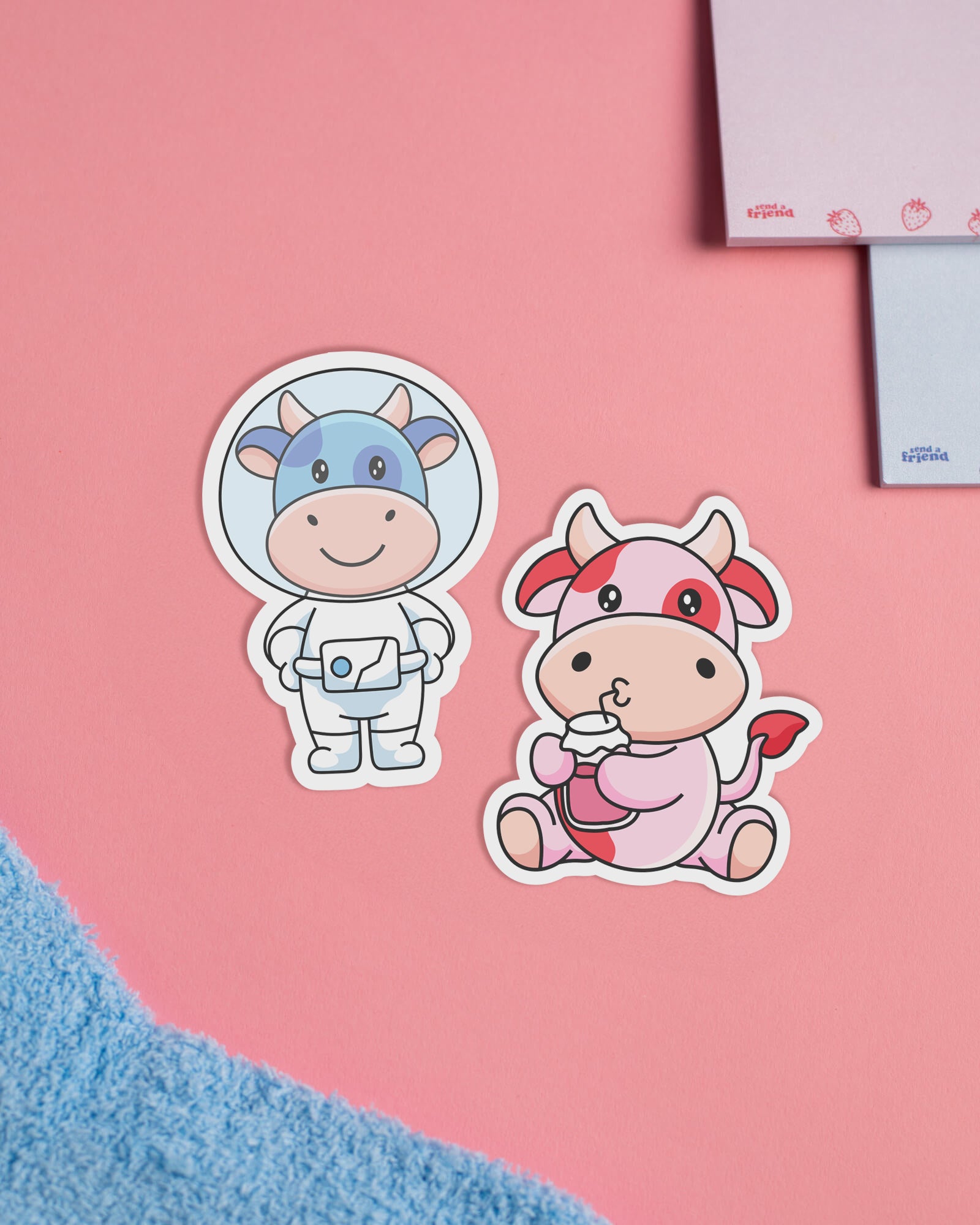 Photo of Strawberry Cow and Blueberry Cow stickers sitting on Someone Loves you box.