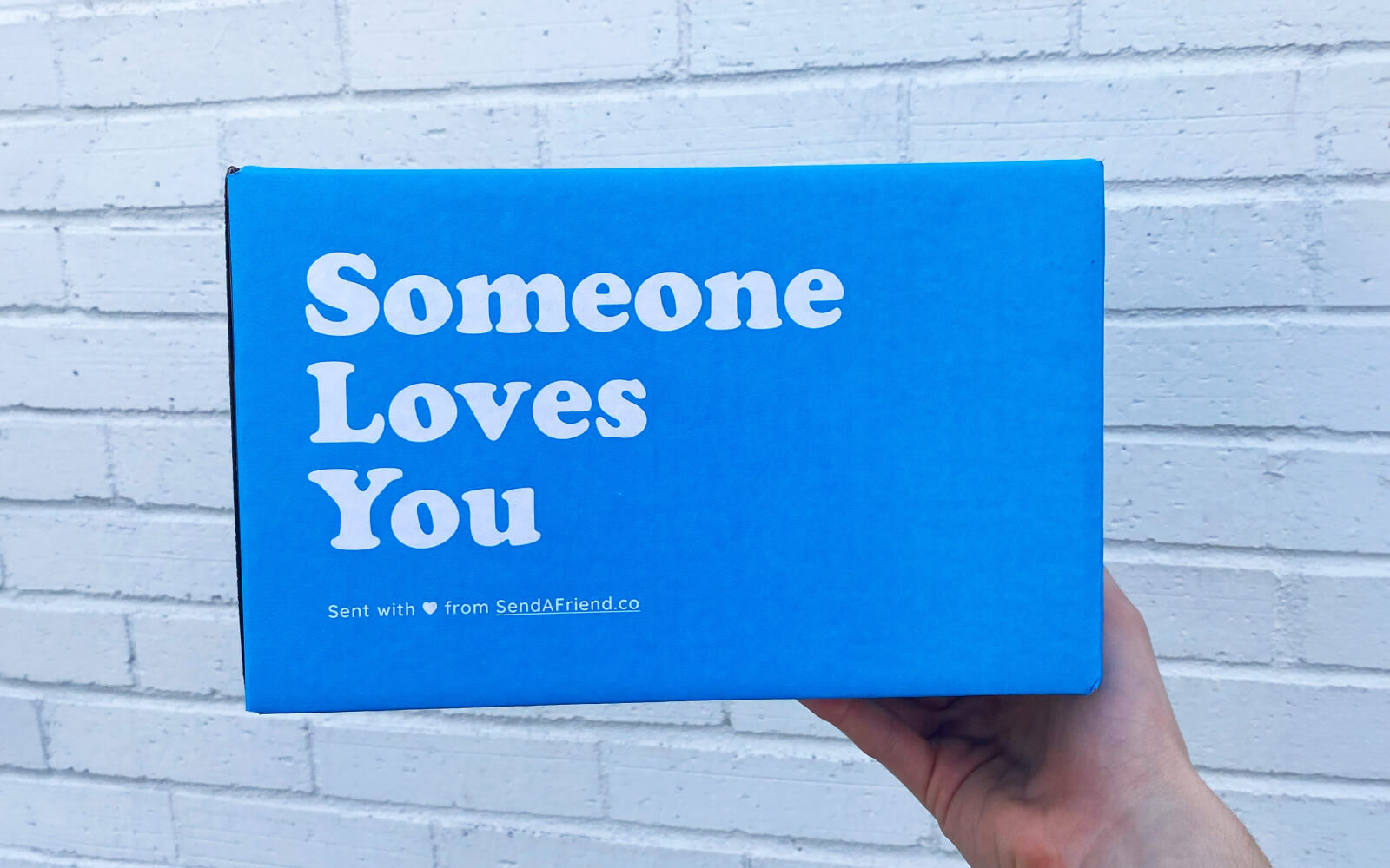 person holding someone loves you box