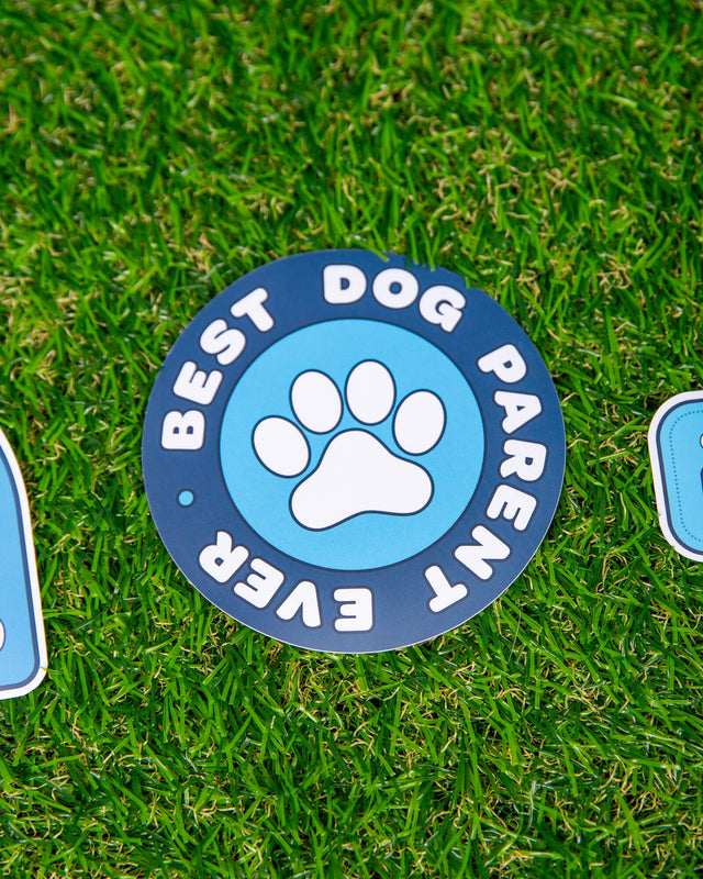Photo of blue circle shaped sticker. Sticker has paw on it and reads Best Dog Parent Ever