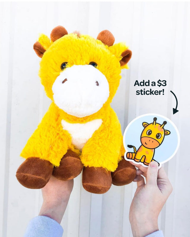 Photo of hands holding yellow George the Giraffe plushie and matching sticker which can be purcahsed for additional $3
