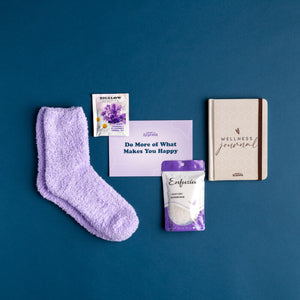 Photo of Self Care Bundle: lavender colored fuzzy socks, lavender and chamomile tea, promo card, lavender bath soak, wellness journal