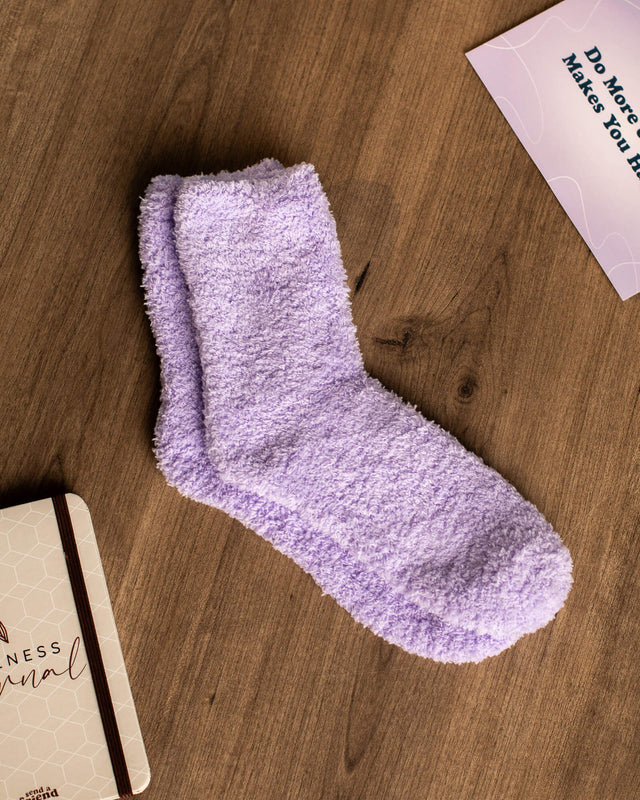 Photo of lavender colored fuzzy socks included with Self Care Bundle