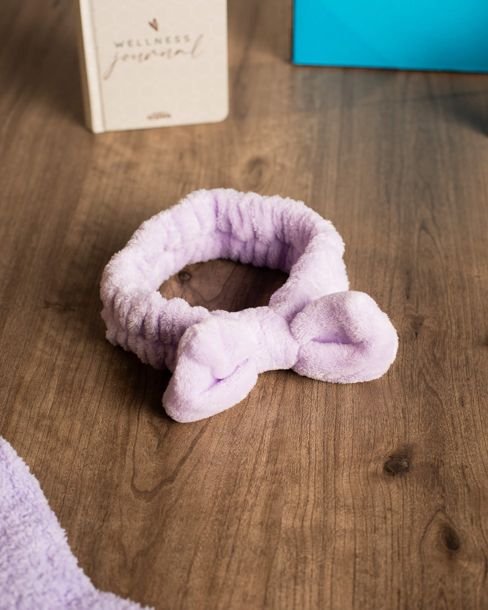 Photo of fuzzy lavender colored headband included in Deluxe Self Care Bundle