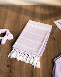 Photo of lavender colored Turkish towel included with Deluxe Self Care Bundle