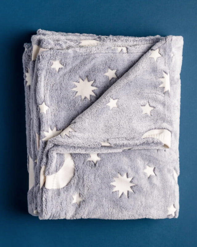 Photo of fluffy moon and stars gray blanket on a blue background