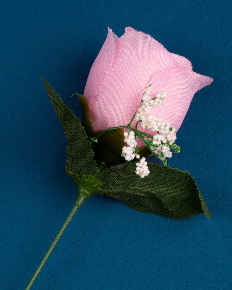 Photo of pink silk rose on a blue background