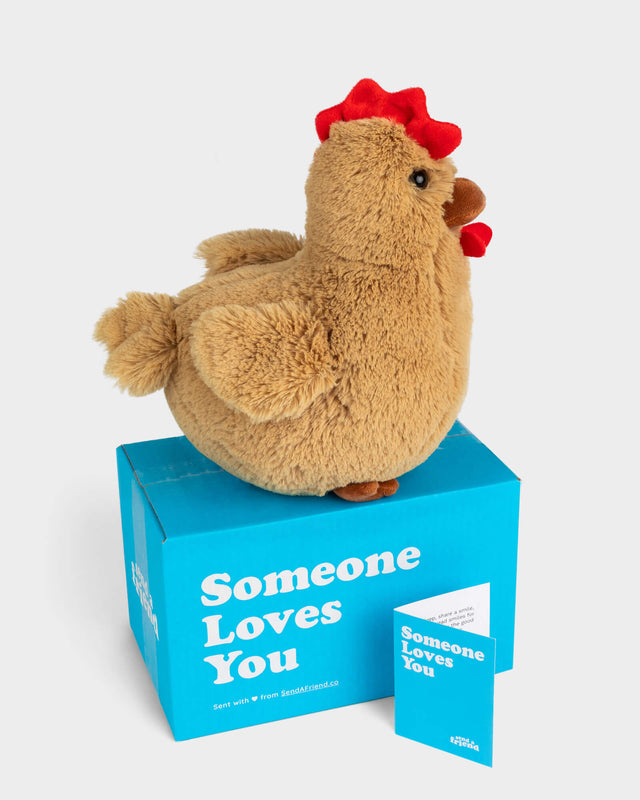 Side view photo of tan Rowdy the Rooster plushie, Someone Loves You box, and note card